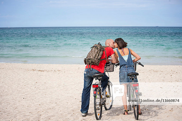 Couple on bicycles on the beach  Mallorca  Spain