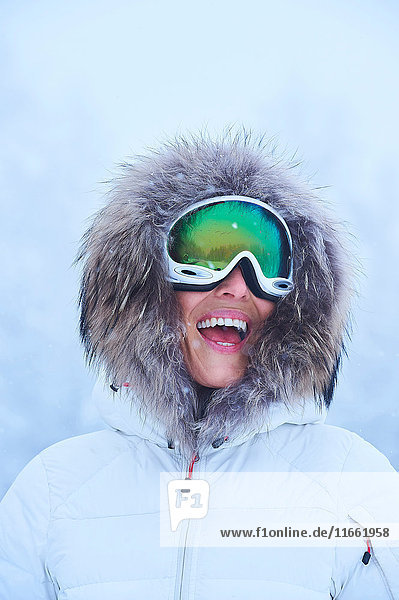 Portrait of happy mature woman in falling snow  Gstaad  Switzerland