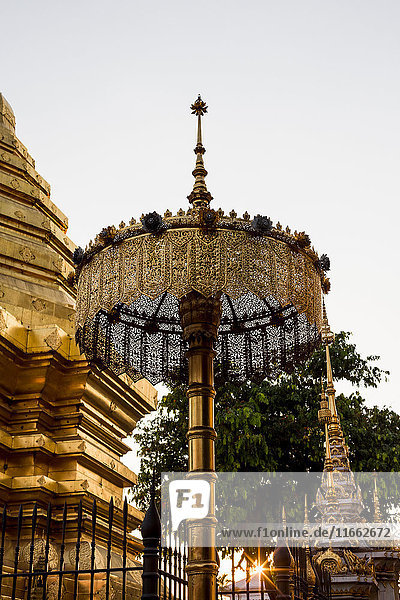 Gateway and golden spires of buddhist temple Chiang Mai Thailand