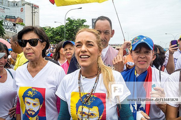 Lilian Tintori  wife of prominent jailed opposition leader Leopoldo Lopez  waves a Venezuelan national flag during a rally against the government of President Nicolas Maduro. Opposition march on Wednesday  May 4  in rejection of the 'constitutional fraud'.