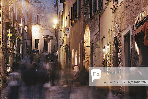 A busy street at night in the Tuscan hill town of Montepulciano.