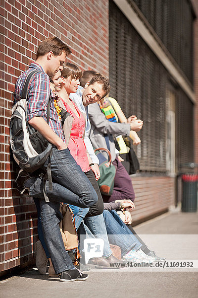 People waiting in line on city street