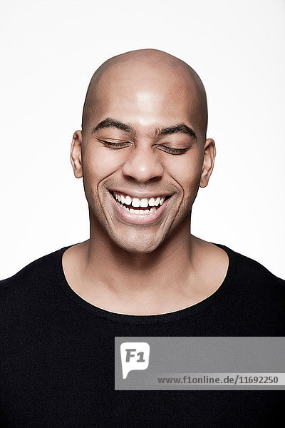 Portrait of man with shaved head  laughing