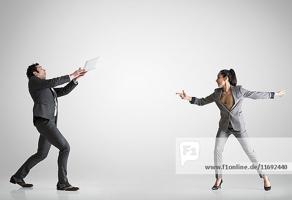 Woman throwing digital table to man