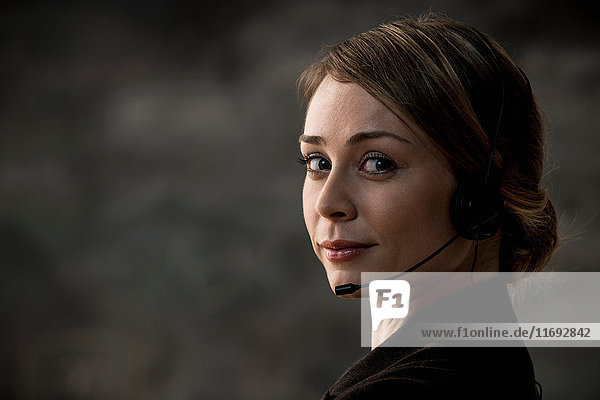 Businesswoman wearing telephone headset
