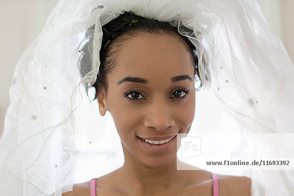 Young woman wearing bridal veil  portrait