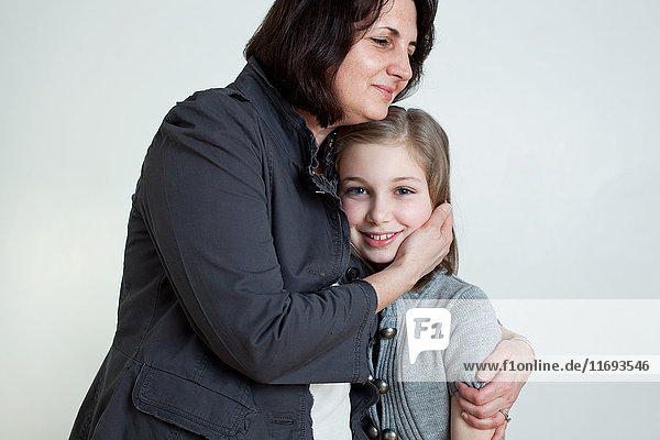 Mature woman hugging daughter  portrait