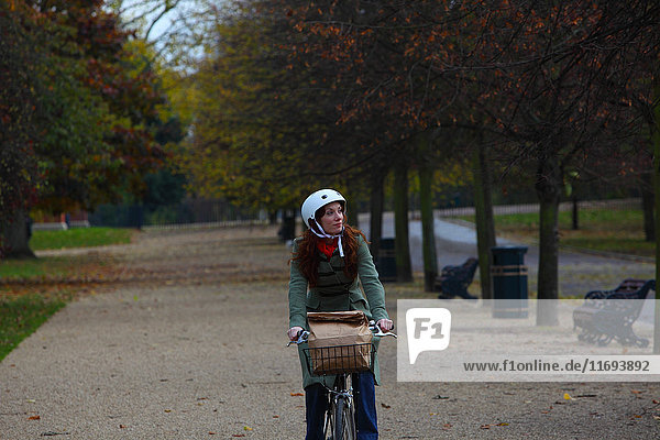 Woman riding bicycle in park