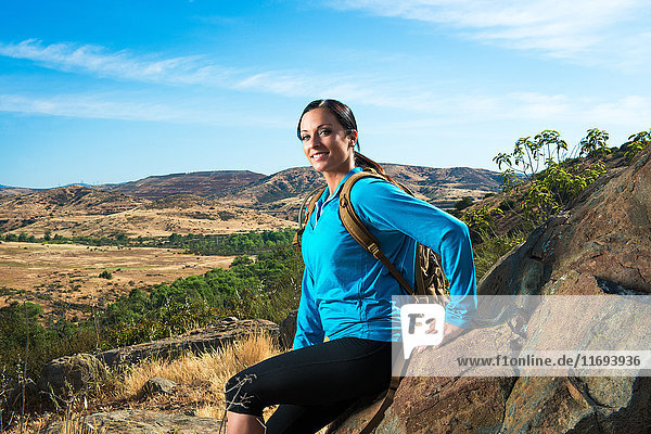 Female hiker sitting on rock