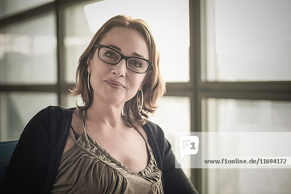 Portrait of mature woman wearing glasses looking at camera