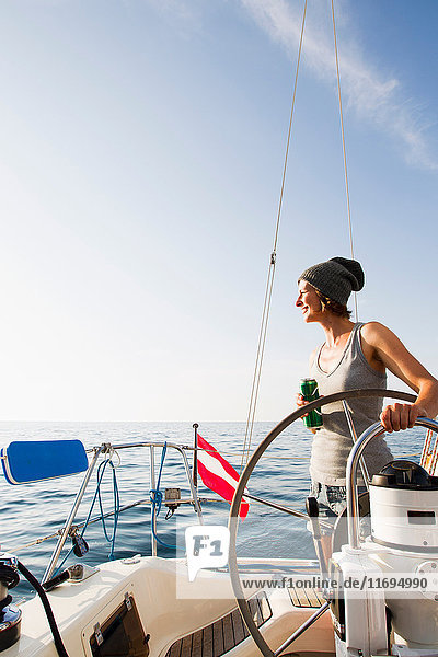 Lächelnde Frau am Steuer eines Bootes