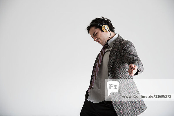 Businessman wearing headphones dancing