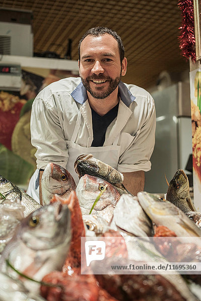 Male fishmonger in market
