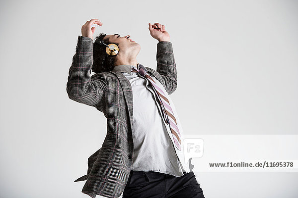 Businessman wearing headphones dancing