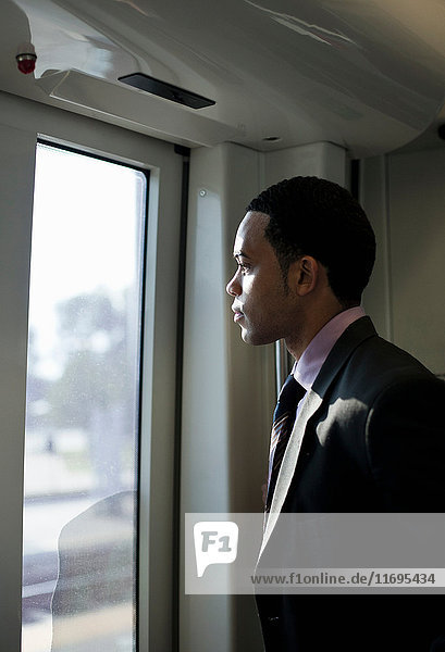 Businessman on a train  looking through window