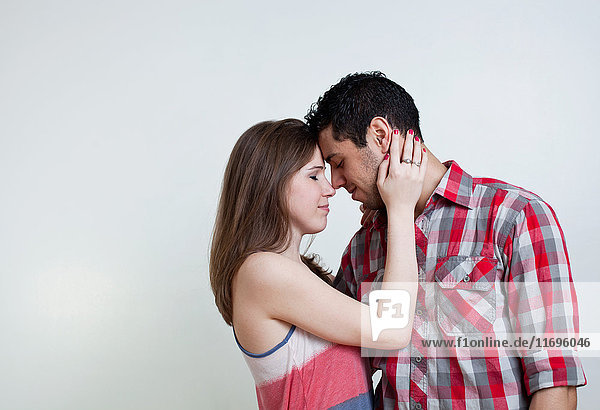 Young couple embracing  studio shot