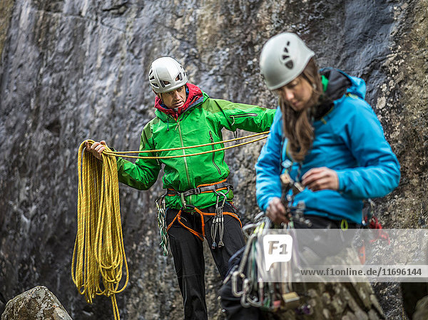 Rock climbers organizing equipment