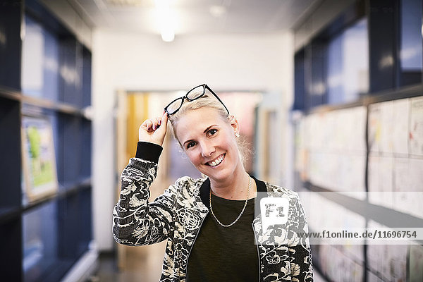 Porträt eines Mittelschullehrers lächelnd im Flur der Mittelschule