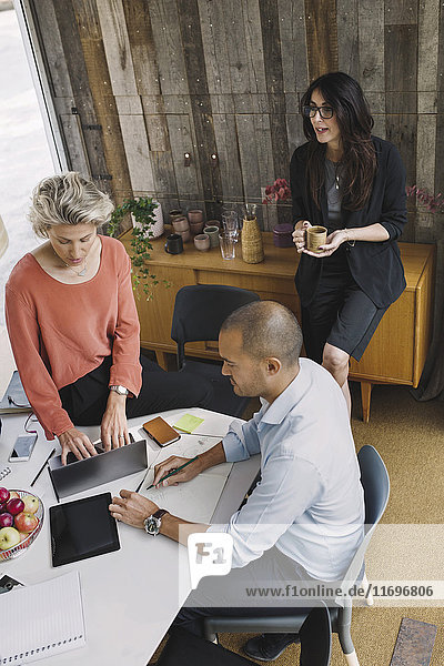 Business colleagues working at desk in portable office truck