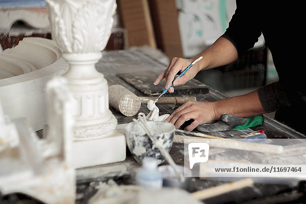 Kaukasischer Künstler beim Bildhauern mit Werkzeug