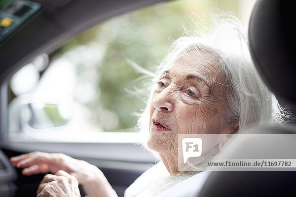 Older Caucasian woman sitting in car