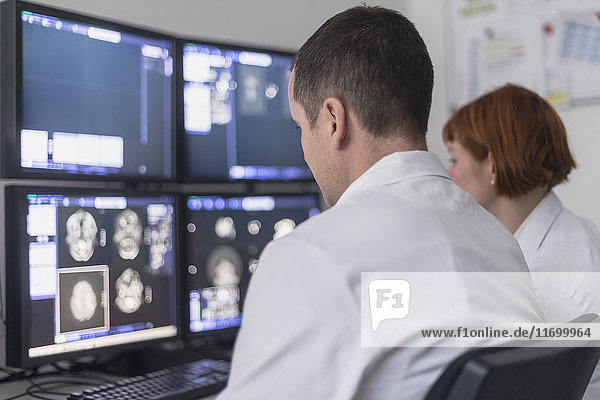 Zwei Ärzte betrachten Röntgenbilder auf dem Computerbildschirm