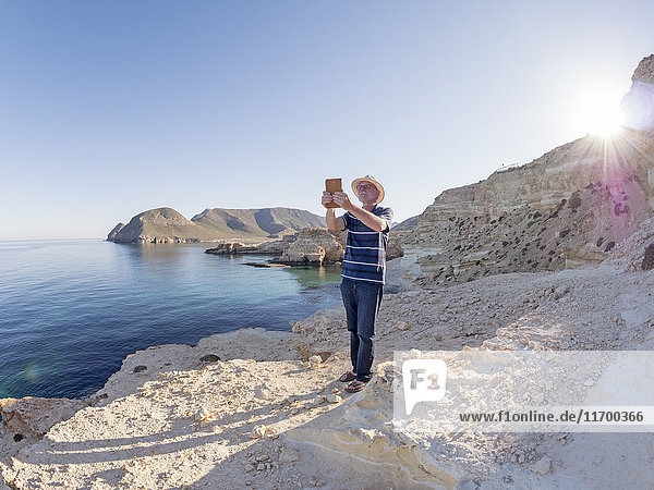 Spain  Andalusia  Cabo de Gata  man taking a selfie at the sea
