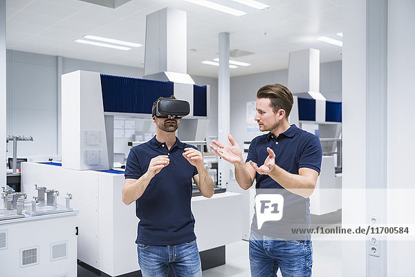 Two men in testing instrument room with VR glasses