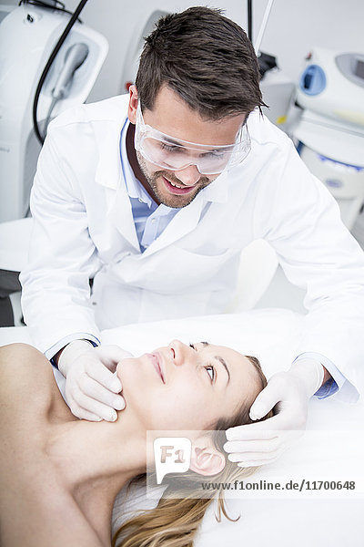 Aesthetic surgery  doctor looking at woman