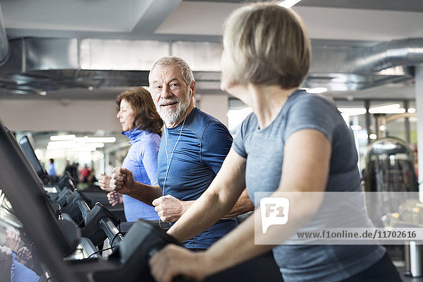 Gruppe von fit Senioren auf Laufbändern im Fitnessstudio