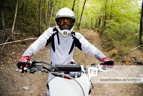 Italy  Motocross biker rinding in Tuscan forest