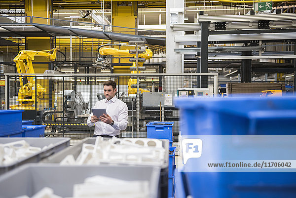 Man using tablet in factory shop floor