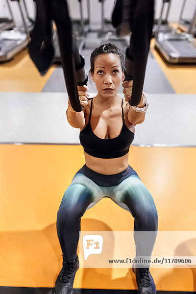 Woman doing suspension traning in the gym