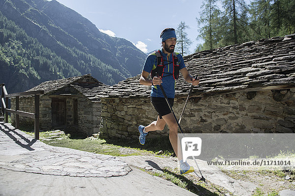 Italy  Alagna  trail runner on the move near Monte Rosa mountain massif