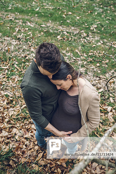 Man with pregnant woman in nature