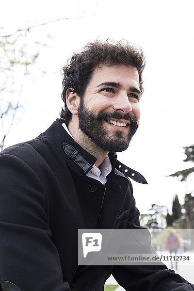 Portrait of smiling young man with full beard
