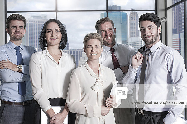 Portrait of confident businessmen and businesswomen in office