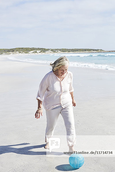 Senior woman having fun on the beach