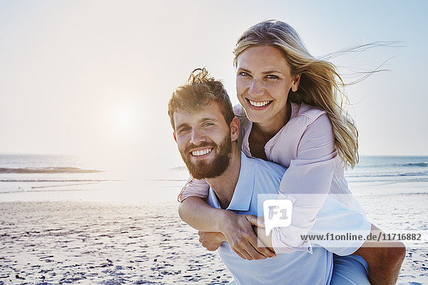 Portrait of happy couple on the beach