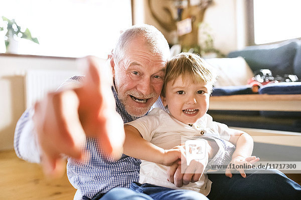 Grandfather and grandson having fun at home