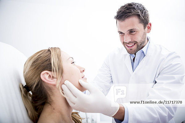 Aesthetic surgery  doctor examining woman