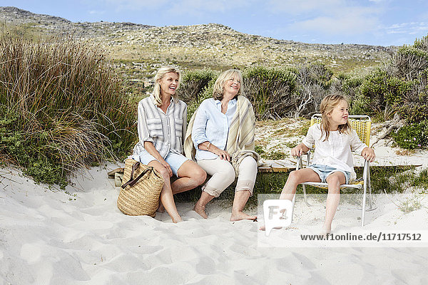 Mutter,  Tochter und Großmutter,  die einen Tag am Strand verbringen.