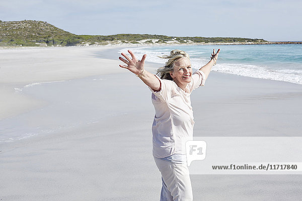 Senior woman having fun on the beach