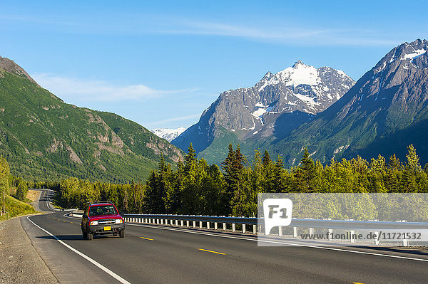 Car on a road with scenic Chugach Mountains in the background  Eagle River  Southcentral Alaska  USA