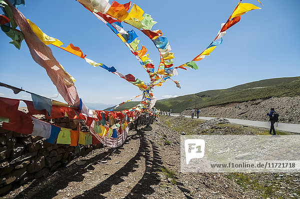 'Prayer flags on the way to Litang a Tibetan village in the west of Sichuan province passing mountains with high altitude; Litang Sichuan China'