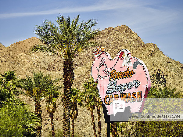 Schild für Rancho Super Car Wash neben Palmen und einer trockenen Landschaft; Palm Springs  Kalifornien  Vereinigte Staaten von Amerika'.
