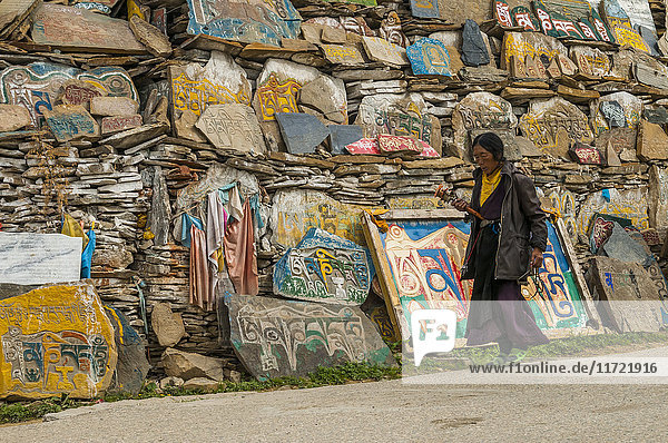 'Litang Monastery in the entrance near to the Stupa many stones carved with the symbols of the mantra ''Om Mani Padme Hum'' West of Sichuan province; Litang Sichuan China'