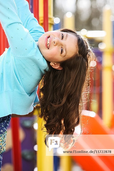 'A young girl posing for the camera while playing at the playground; Oregon  United States of America'
