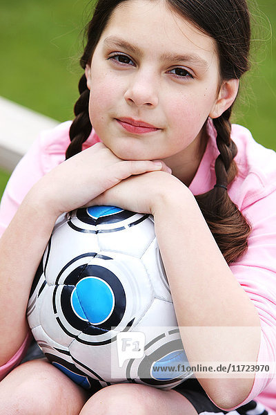 'Portrait of a young girl with her soccer ball; Oregon  United States of America'