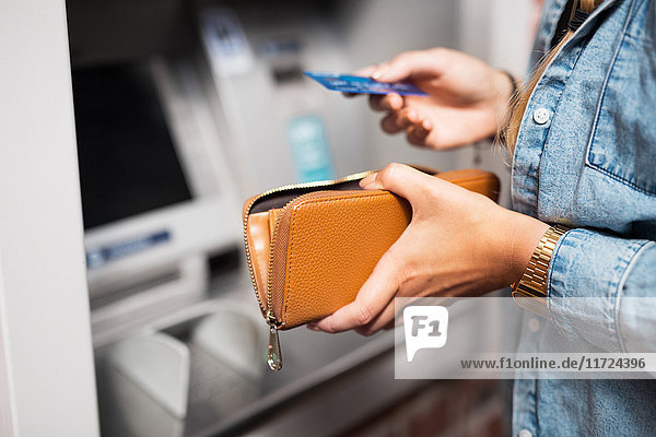 Woman withdrawing money from ATM